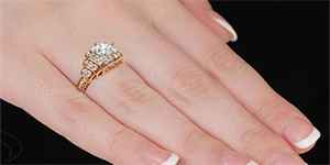 Hand with terraces style vintage diamond engagement ring in rose gold