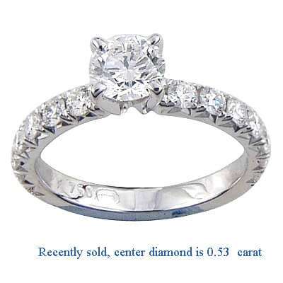 Engagement ring side set with round diamonds