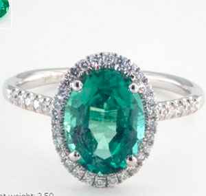 Emerald oval stone in diamonds halo engagement ring
