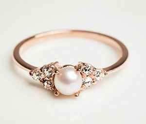 Pearl in a rose gold ring with side diamonds