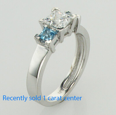 Two aquamarine side stones engagement ring