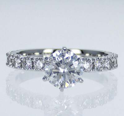 Engagement ring side set with round diamonds
