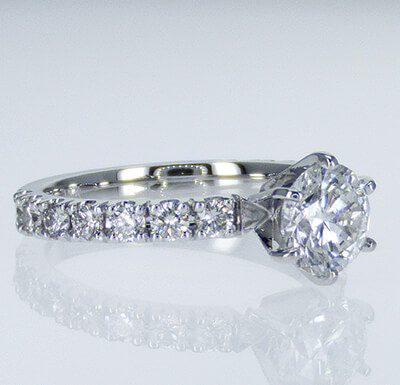 Engagement ring side set with round diamonds