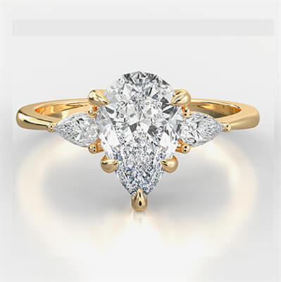 Three stone diamond engagement ring with 0.20 CTW side Pear diamonds