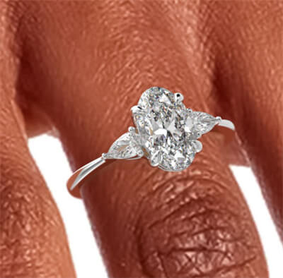 Three stone engagement ring with 0.20CTW side Pear diamonds