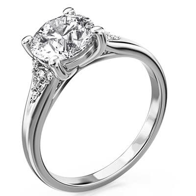 Round diamond engagement ring with split band and side diamonds